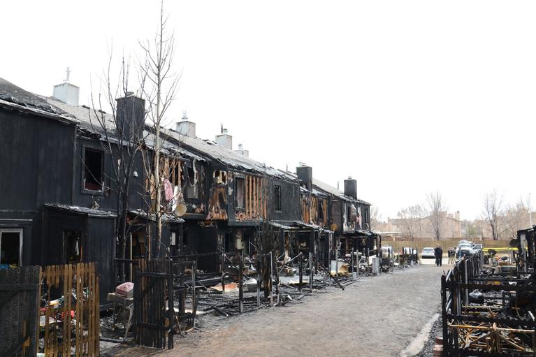 Charred shell of an apartment building at the scene of a fire investigation